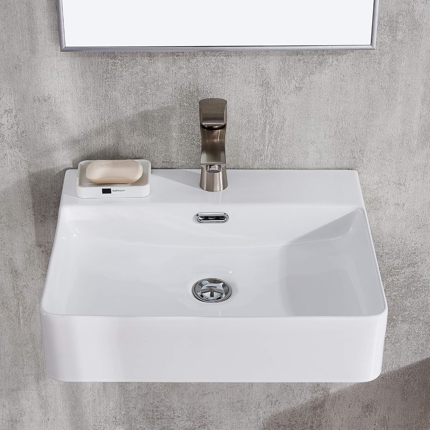 Wall-mounted white ceramic basin